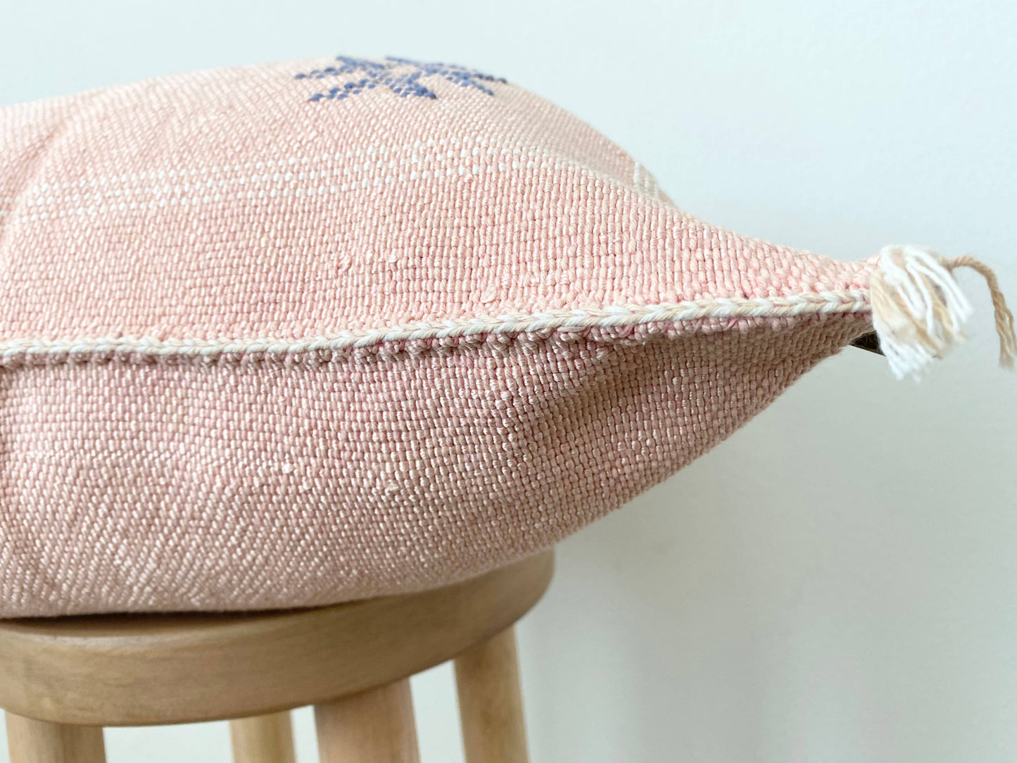 Pink Silk Sabra Cushion cover on a stool